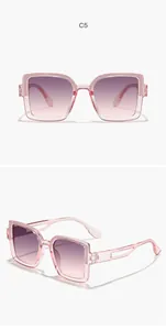 Detail view of pink children's sunglasses with square glitter frames and gradient lenses
