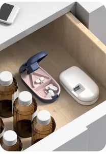 Japanese style pill cutter splitter and organizer stored in a drawer with medicine bottles