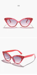 Close-up of pink glitter cat-eye sunglasses for kids with rhinestone inlay and gradient lens