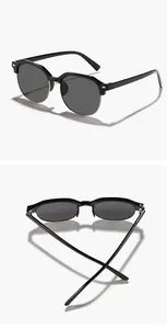 Detailed view of kids half-frame square sunglasses in black with metal rims.