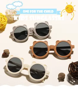 Close-up view of cute bear-ear kids sunglasses in taupe, brown and cream colors.