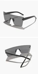 Detailed view of oversized rimless shield sunglasses with a flat top and dark lenses.