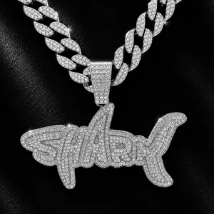 Detailed view of hip-hop shark pendant with iced-out rhinestones on cuban link chain