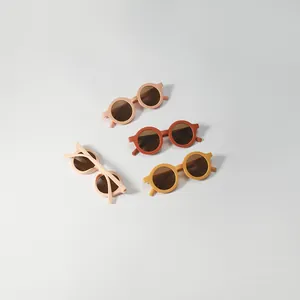 Stylish round children's sunglasses with matte frames in warm earthy tones for UV protection