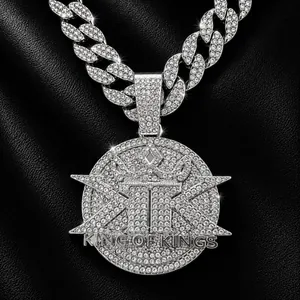 Macro view of iced-out KING OF KINGS pendant with sparkling full rhinestone pavé.