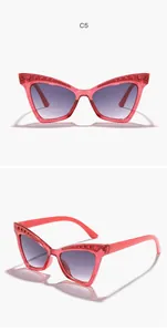 Close-up of children's cat-eye sunglasses with pink glitter and rhinestone frames