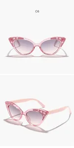 Detail view of pink glitter cat-eye sunglasses for kids with rhinestone accents