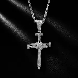 Gros plan d'un pendentif croix hip-hop en argent fait de clous glacés sur fond cuir.