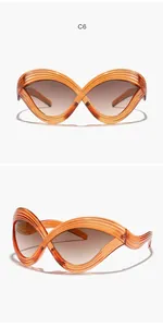 Vorder- und Seitenansicht der übergroßen bernsteinfarbenen Cat-Eye-Sonnenbrille mit Linien