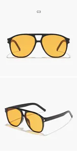 Occhiali da sole aviator vintage con montatura nera e lenti gialle per uno stile street retrò.