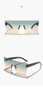 Detailed view of oversized rimless sunglasses with teal to orange gradient lenses
