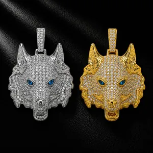 Macro view of iced-out wolf head pendants with blue stone eyes in gold and silver finish