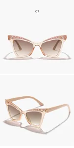 Detail of children's glitter cat-eye sunglasses with rhinestone accents in pink