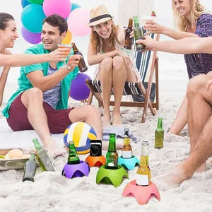 Set of portable colorful plastic beach cup holders keeping drinks stable in the sand