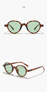 Detailed view of round tortoiseshell sunglasses with light green lenses for outdoor style