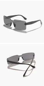 Professional detail view of retro rimless rectangular sunglasses with dark grey lenses