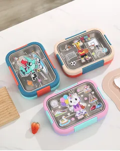 Detail of three cartoon stainless steel bento boxes with dinosaur, giraffe, and unicorn designs.