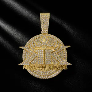 Detailed close-up of gold iced-out King of Kings hip hop pendant with clear stones