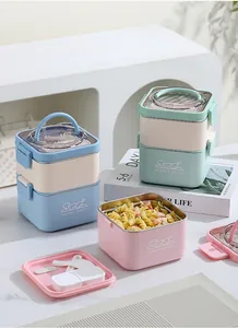 Detailed macro view of stackable square stainless steel bento boxes with handles.