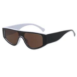 Trendy black and white contrast shield sunglasses featuring large brown tinted lenses.