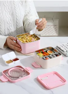 Portable pink square stainless steel bento box with dividers for student and office lunch.