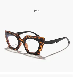 Stylish tortoise-shell cat-eye glasses with irregular frame design and clear lenses.