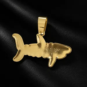 Detailed view of the gold-tone shark pendant from a hip-hop style jewelry collection