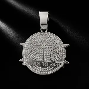 Detail view of iced out silver KINGS letter pendant with crown for hip hop men's style.
