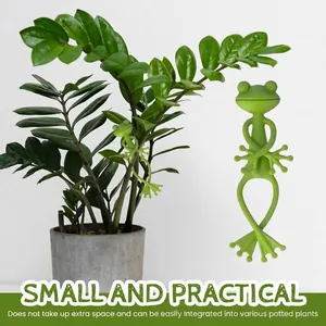 Close-up view of flexible green frog plant tie integrated into a leafy potted plant.