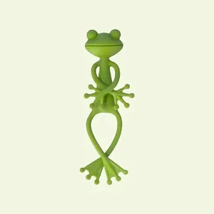 Close-up of a flexible green frog-shaped plant support tie for garden stem fixing