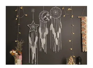 Handmade white bohemian dreamcatchers with moon and star shapes for wall decoration.