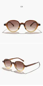 Detailed close-up of brown round frame sunglasses featuring gradient lenses and light shadows