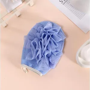 Close-up detail of the 2-in-1 exfoliating bath glove showing the soft purple mesh texture
