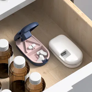 Portable pill cutter and splitter with medicine storage box in a wooden drawer scene