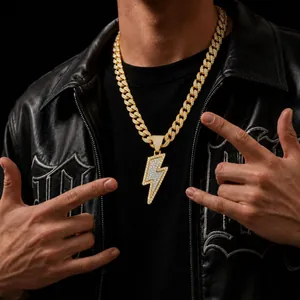 Detailed close-up of a men hip hop iced out gold lightning bolt pendant on a Cuban chain