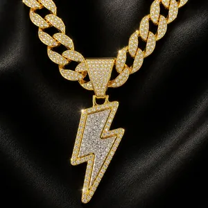 Macro detail of iced out gold lightning bolt pendant with sparkling rhinestones