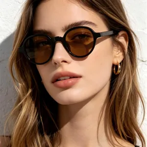 Fashionable round frame sunglasses with brown lenses worn by a model in sunlight