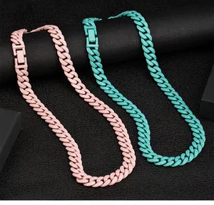 Detail view of pink and teal matte candy colored Cuban link necklaces made of steel