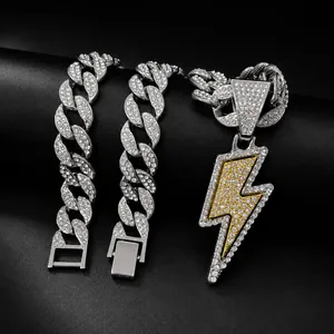 Close-up of iced-out lightning bolt pendant and matching Cuban link chain jewelry set.