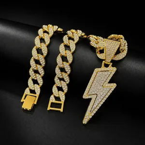 Close-up of gold-tone hip-hop Cuban link chain and rhinestone lightning pendant