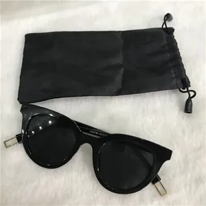 Portable black fiber drawstring pouch for sunglasses and small accessories storage.