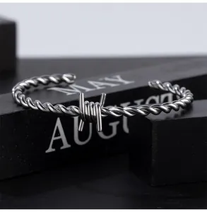 Close-up of titanium steel barbed wire cuff bracelet for men with twisted cable design