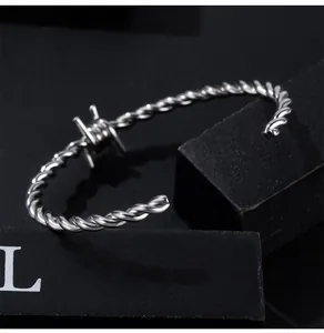 Close-up detail of a men's titanium steel twisted cuff bracelet with barbed wire design