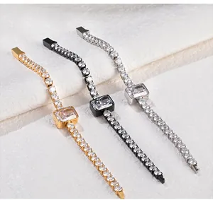 Close-up of elegant zircon tennis bracelets in gold, black, and silver finishes.