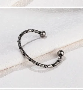 Detailansicht des vintage gedrehten Armreifs aus Titanstahl mit Metallstruktur