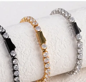 Detail view of sparkling zircon tennis bracelets in gold, silver, and black finishes