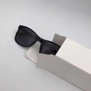 Classic black square sunglasses partially placed in a white portable paper packaging box