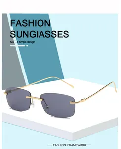Detail of retro rimless square sunglasses with gold metal frame and grey lenses