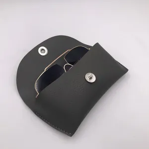 Detailed view of a vintage grey faux leather sunglasses case with metal snap closure