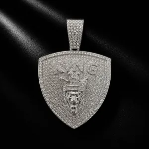 Detailed view of hip hop style iced out shield pendant with lion head and KING text